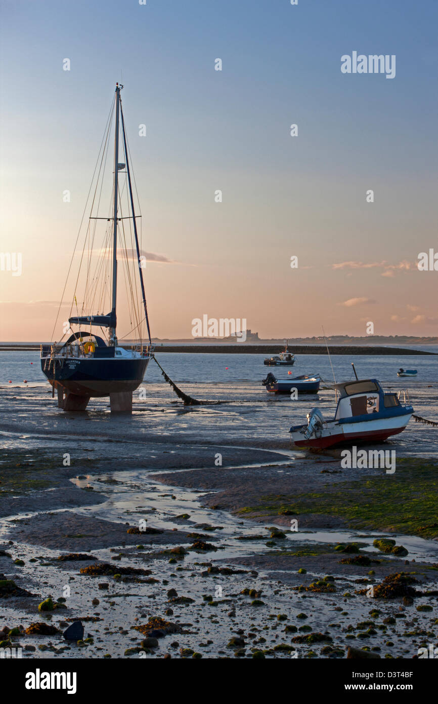 Bamburgh Castle at dawn seen from Lindisfarne, Northumberland Stock Photo