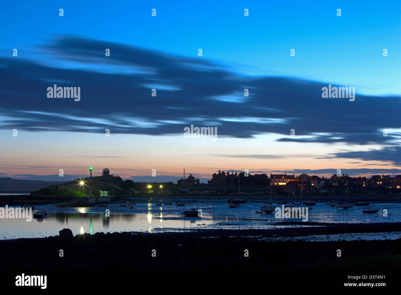 A view at twilight of Lindisfarne village on the Holy Island of Lindisfarne in Northumberland looking westwards Stock Photo