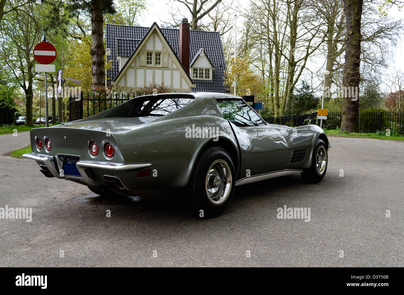 Iconic sportscar Chevrolet Corvette C3 Stingray in silver-grey in front of a luxury house. Stock Photo