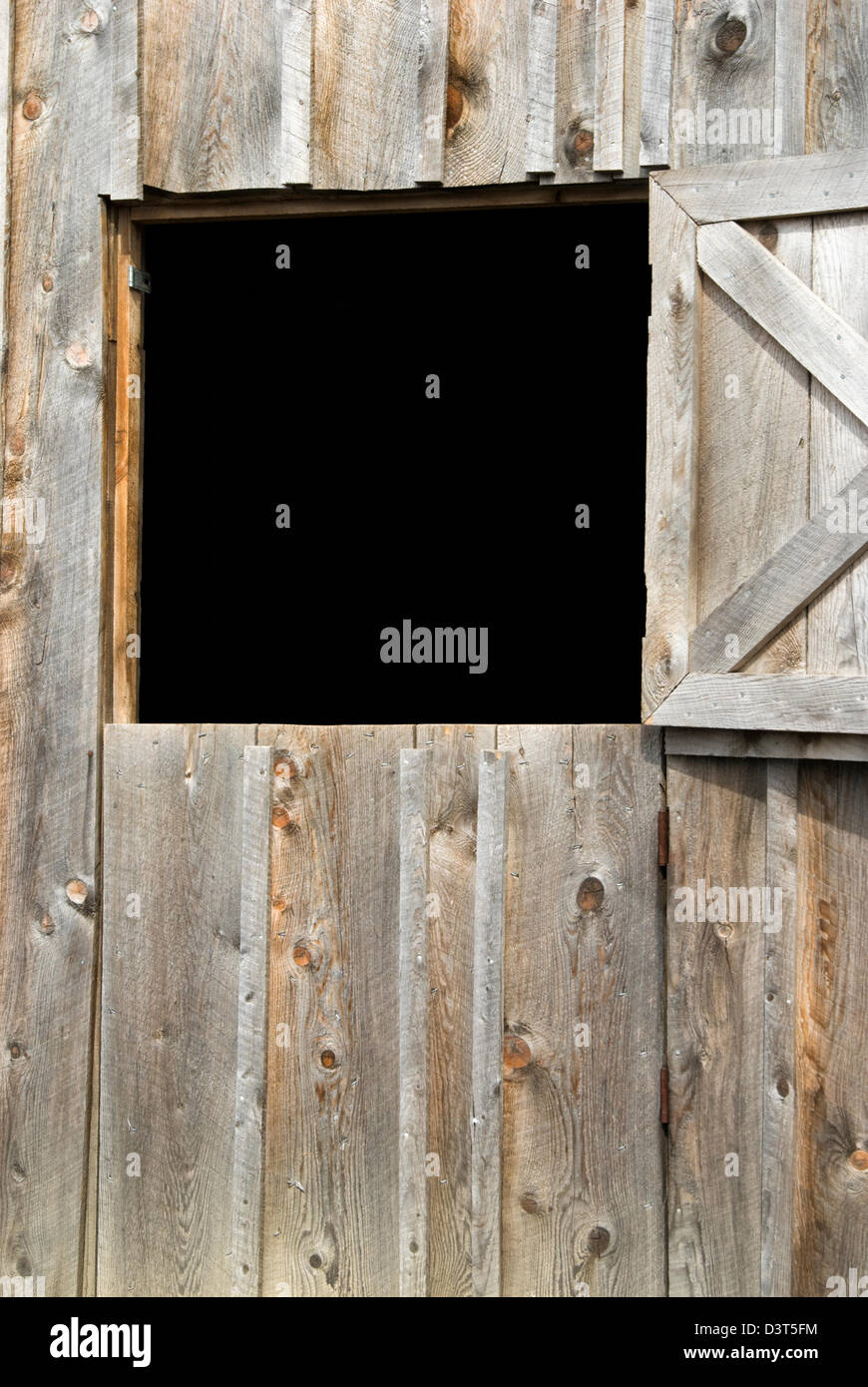 Barn door open to black background as a design element, a dutch door