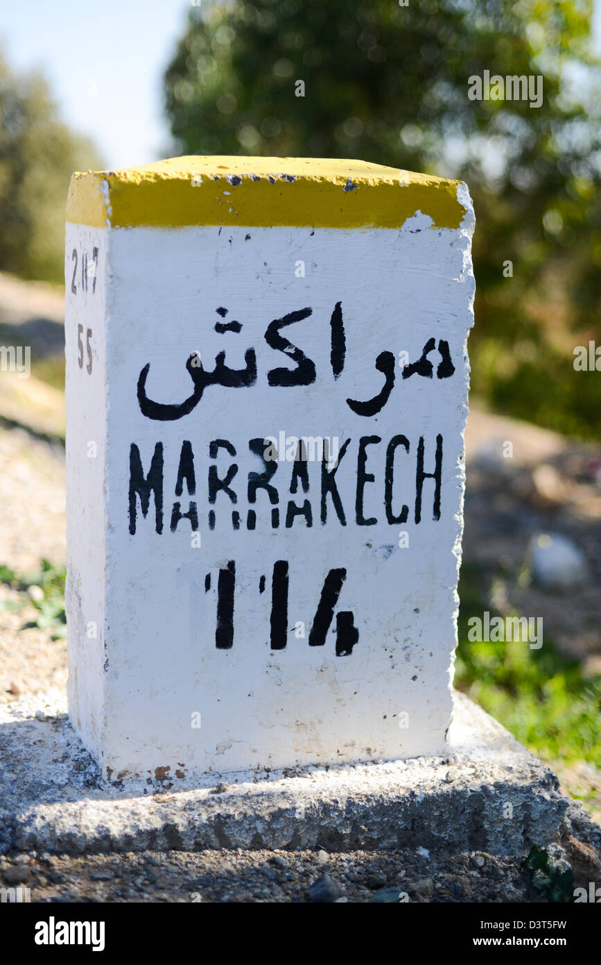 Milestone for Marrakech along the road from Essaouira Stock Photo