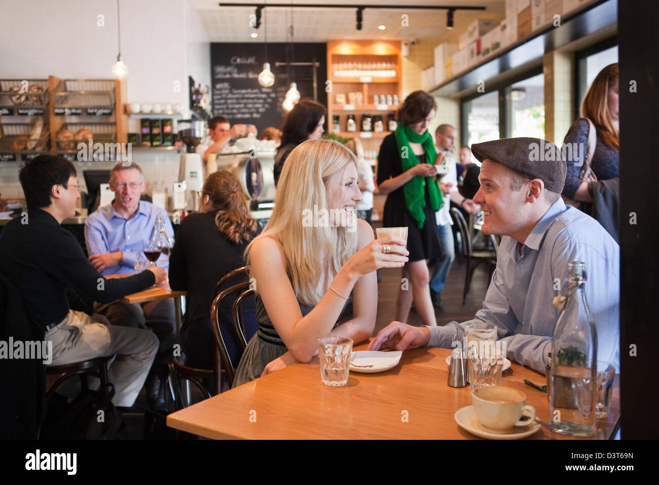 Young couple relaxing and drinking coffee in cafe. Canberra, Australian