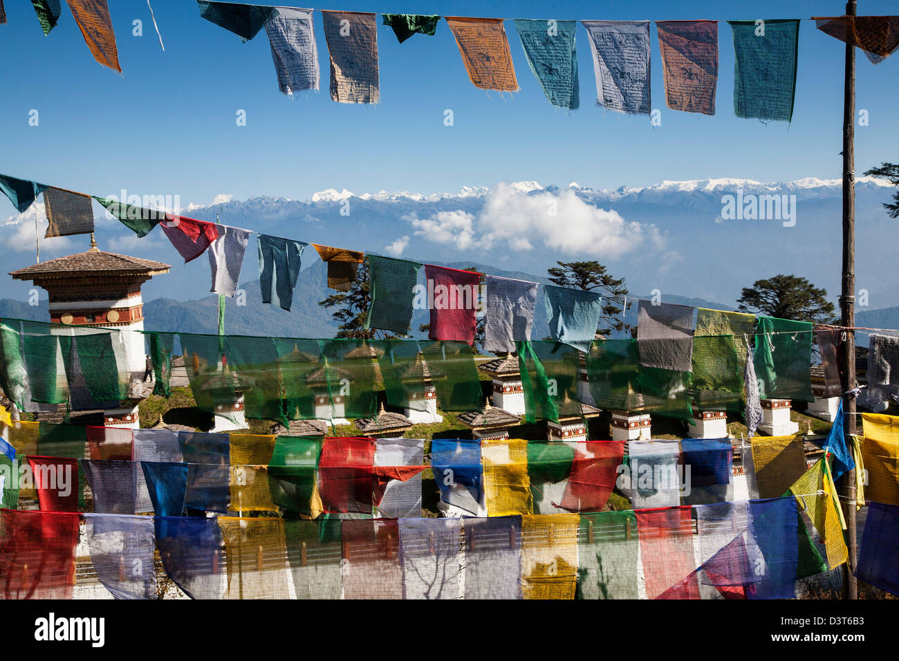 Prayer flags decorate Dochula (pass) at 3,150 metres high with the eastern Himalaya in the background. Stock Photo