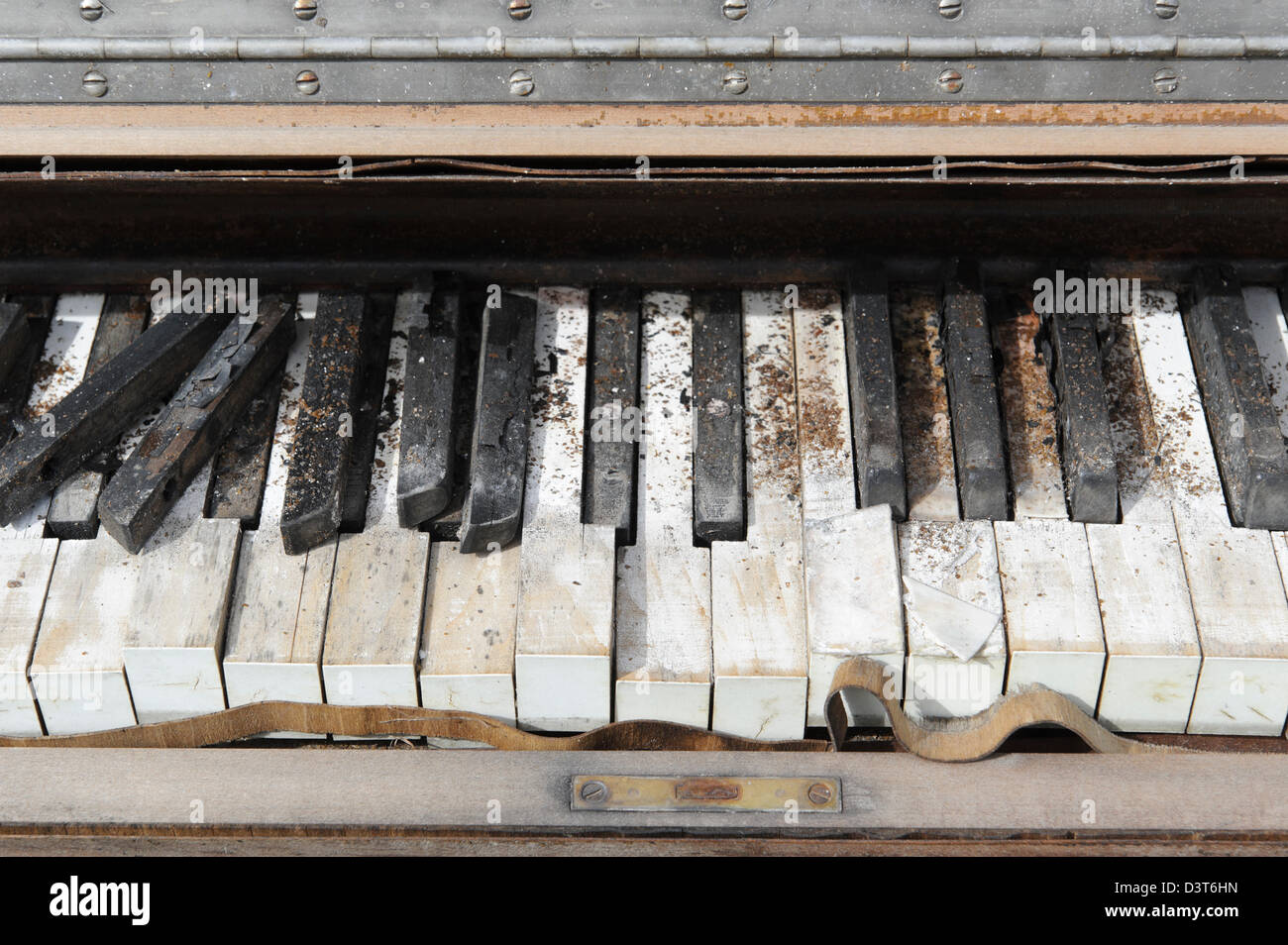 Piano keys close up, an abandoned grunged and broken keyboard sitting outside in the weather. Stock Photo