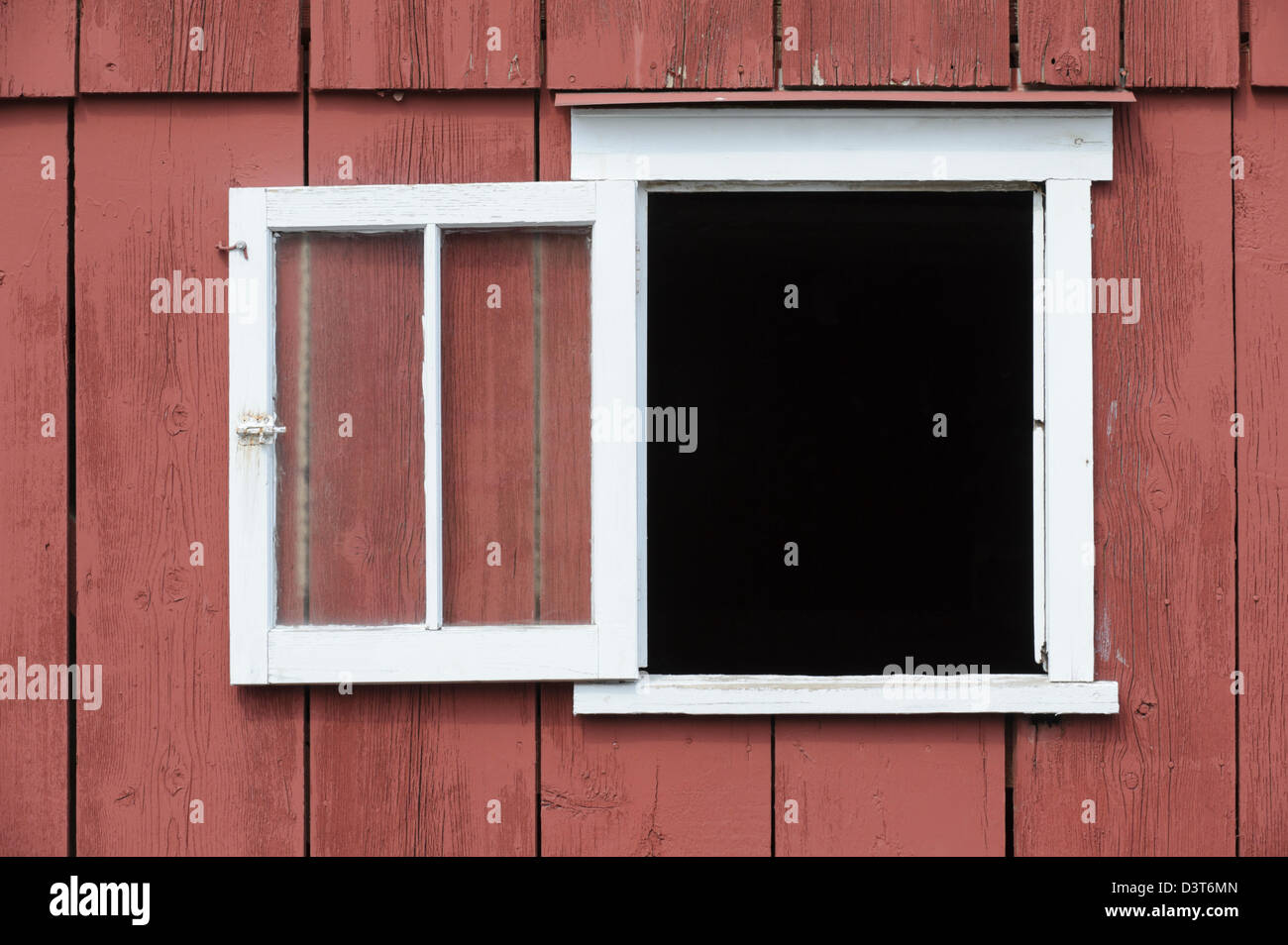 Open window in red barn with white trim as a design element, place your own image in the opening. Stock Photo
