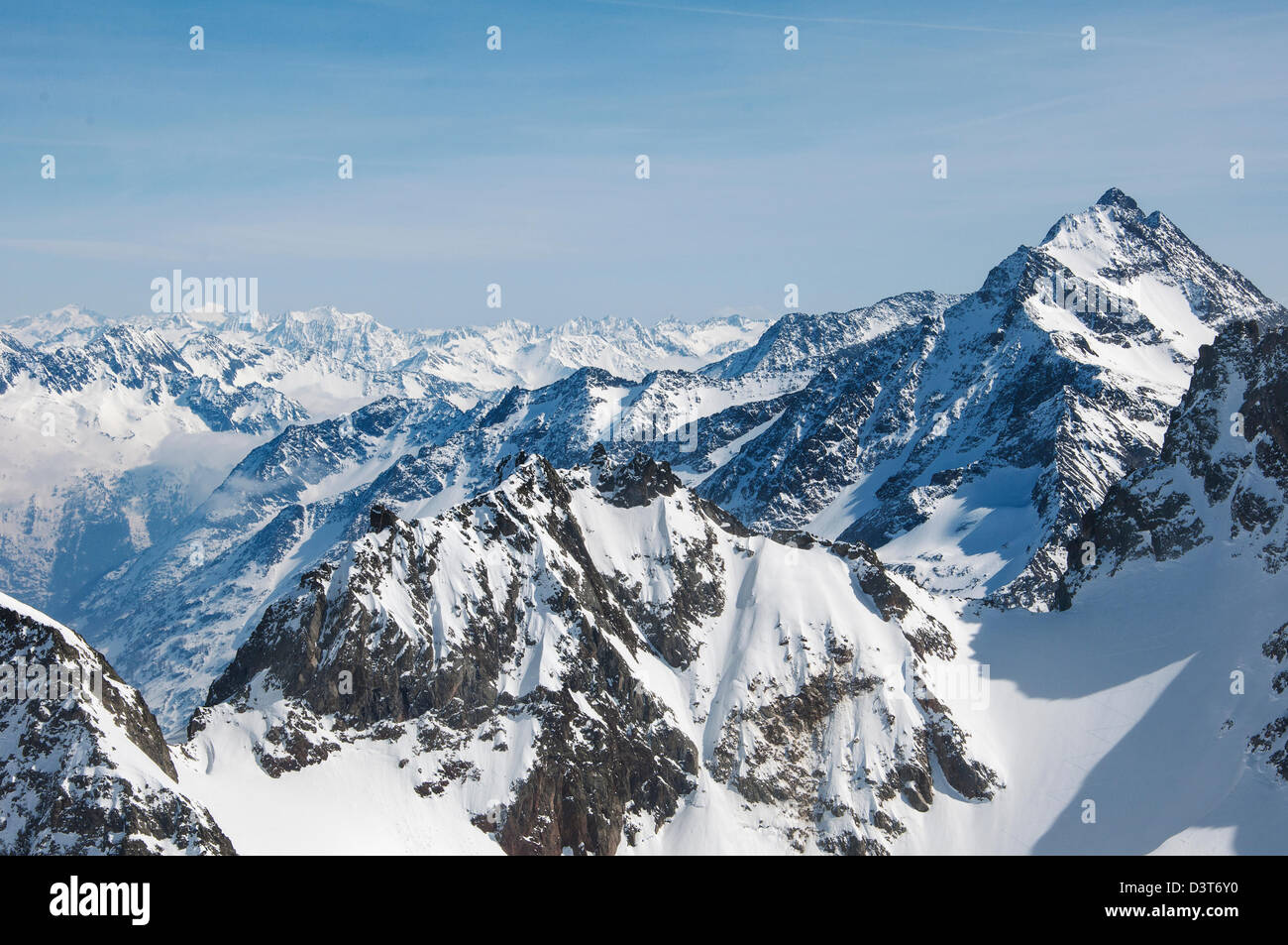 A view of snowcapped rocky alpine mountain range in Switzerland Stock Photo