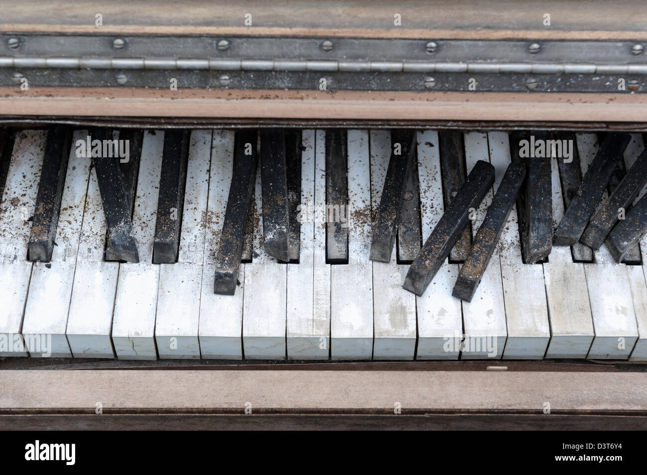 Piano keyboard close up sitting abandoned grunged and broken keyboard sitting outside in the weather. Stock Photo