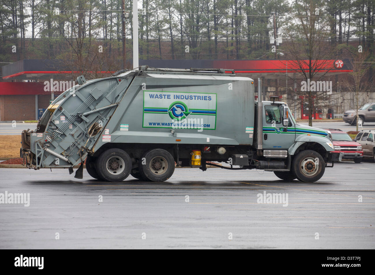 A new, clean garbage truck in a parking lot in the rain Stock Photo Alamy