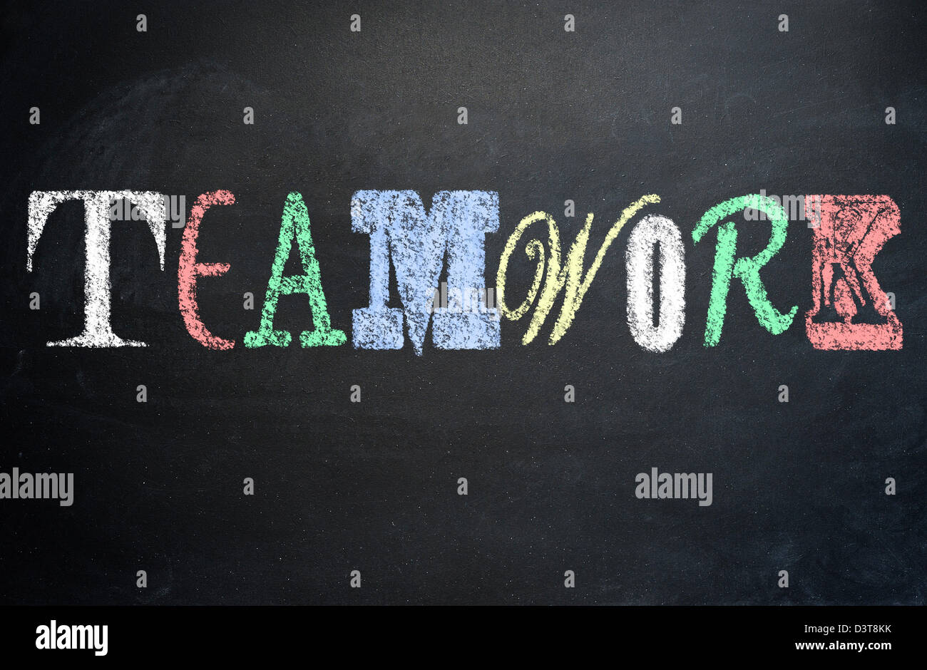 Working together concept, teamwork, diversity concept written with various letter fonts on a blackboard Stock Photo