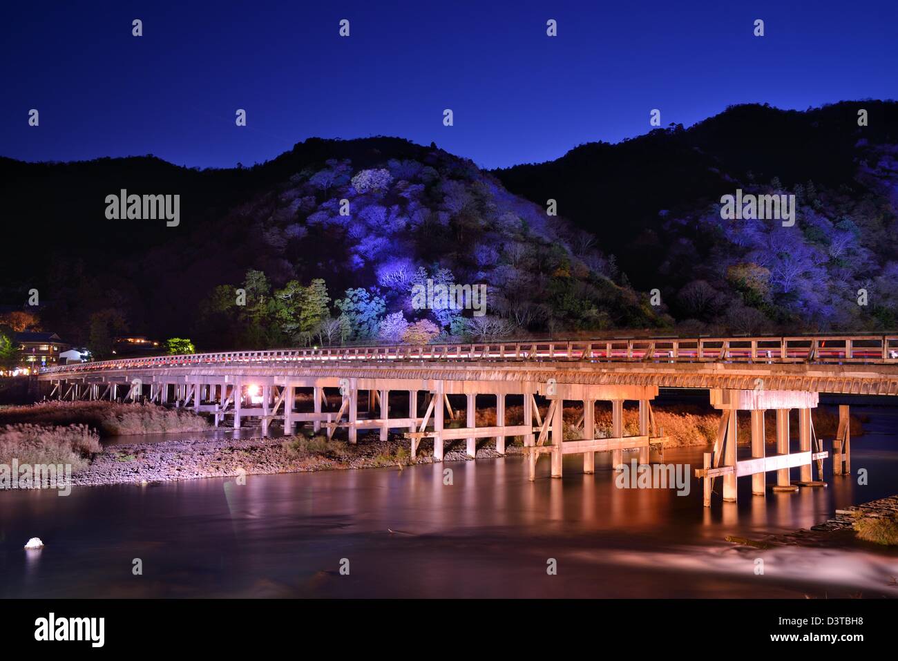 The historic Togetsukyo Bridge, illuminated at night in the Arashiyama district of Kyoto, Japan. Stock Photo