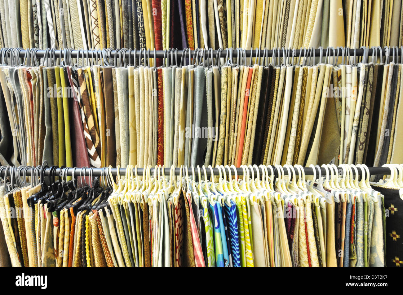 Rows of hanging fabric samples. Stock Photo