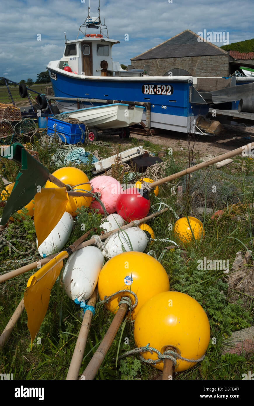 Lobster or crab fishermen's boat and marker floats or buoys, Bulmer, Northumberland Stock Photo