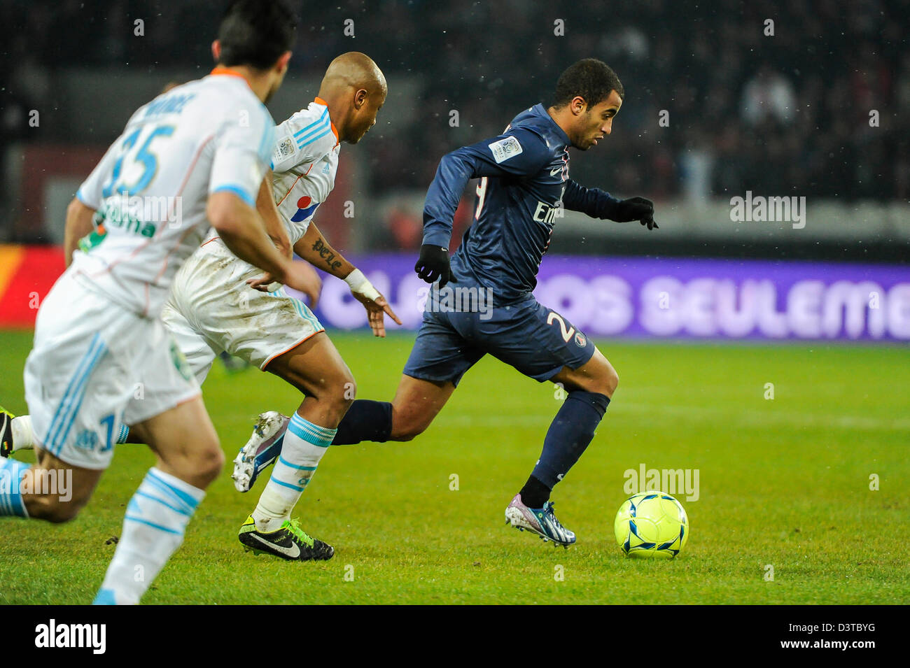 Paris, France. 24th Feb, 2013. . Football (Ligue 1), 26th round, PSG vs OM 2-0. Andre Ayew (OM), Lucas Moura (PSG). Photo Frédéric Augendre Stock Photo