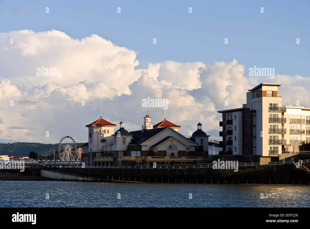 Knightstone island in Weston Super Mare, with large storm clouds in the background and raking sunlight hitting the apartments. Stock Photo