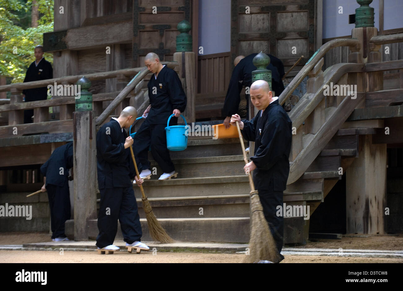 Buddhist monks on cleaning duty at Saito West Pagoda in the Danjo Garan complex of Kongobuji Temple atop Koyasan (Mount Koya) Stock Photo