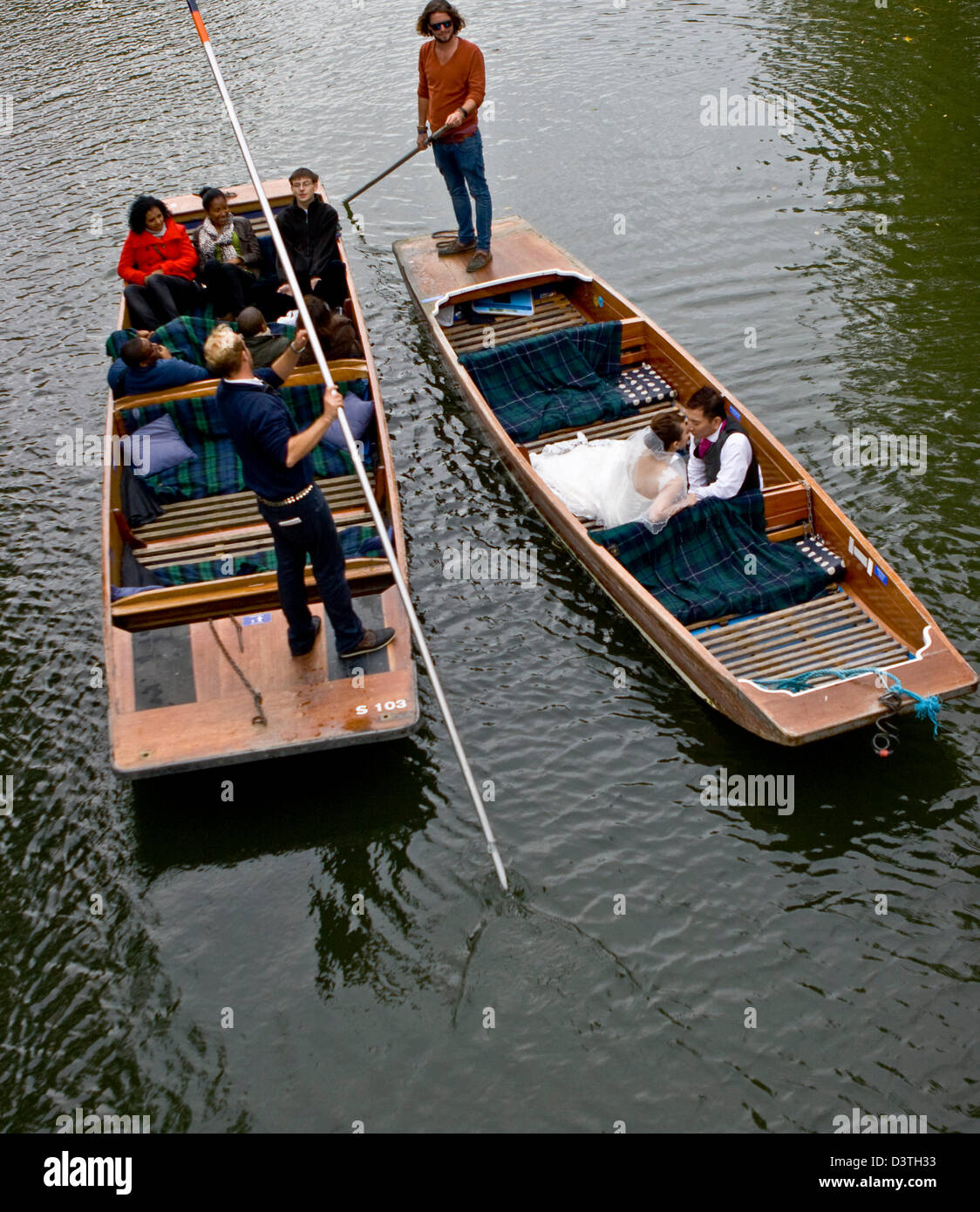 Asian bride and groom kissing in a punt on The Backs River Cam Cambridge Cambridgeshire England Europe Stock Photo