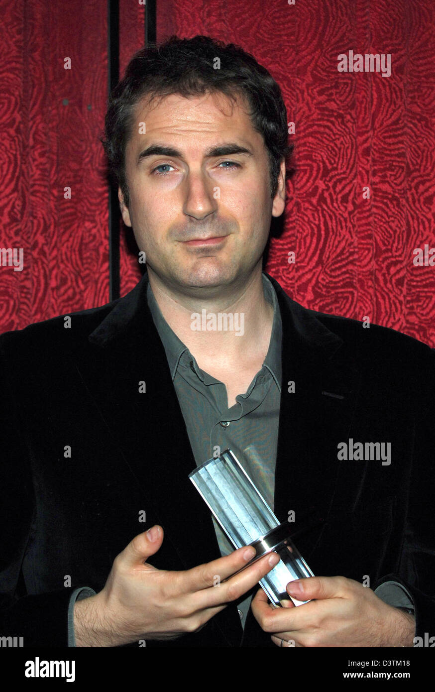 French director Xavier Giannoli holds the 'Douglas-Sirk-Prize', which was awarded to French actor Gerard Depardieu, in his hands at the Film Festival in Hamburg, Germany, Tuesday, 10 October 2006. Depardieu was hindered due to shooting assignements. His film 'Quand j' étais chanteur' premiered after the award ceremony. Photo: Wolfgang Langenstrassen Stock Photo