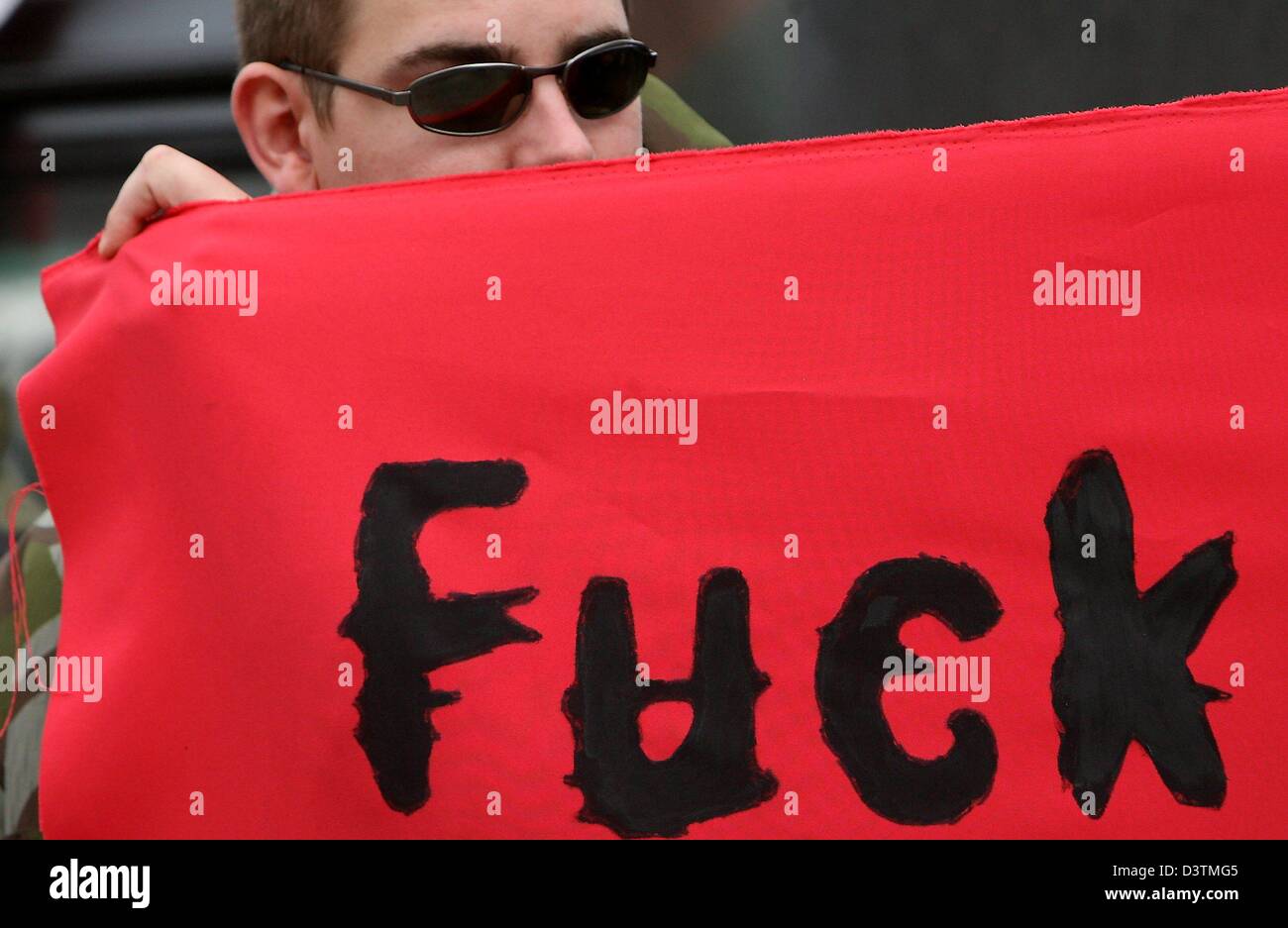 A rightist extremist demonstrant holds a poster at a demonstration of the National Democratic Party of Germany (NPD) in Hamburg, Germany, Saturday, 14 October 2006. More than 1000 leftist demonstrants demonstrated against the NPD. Photo: Maurizio Gambarini Stock Photo