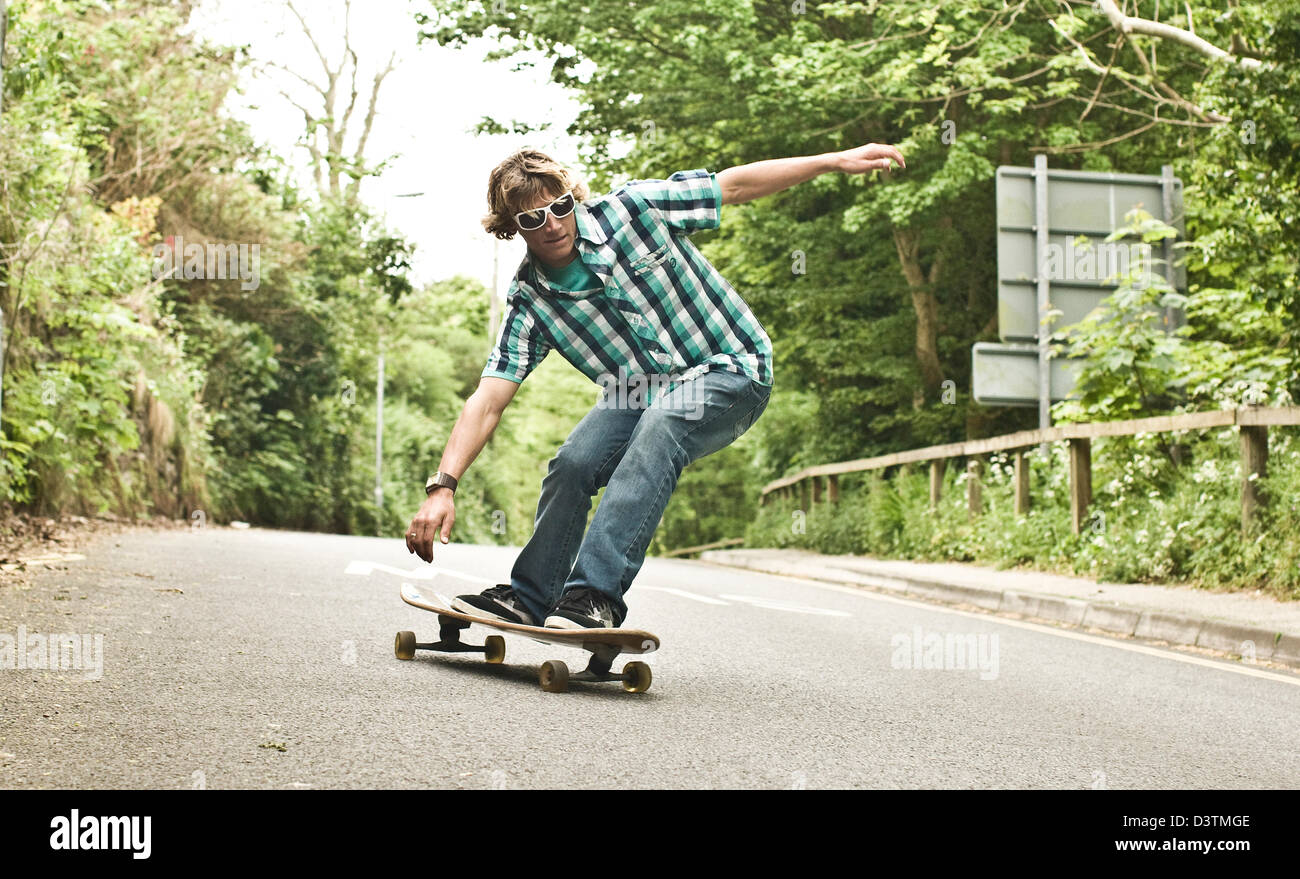 Skateboarding downhill, determination and balance, St Agnes, Cornwall, UK Stock Photo