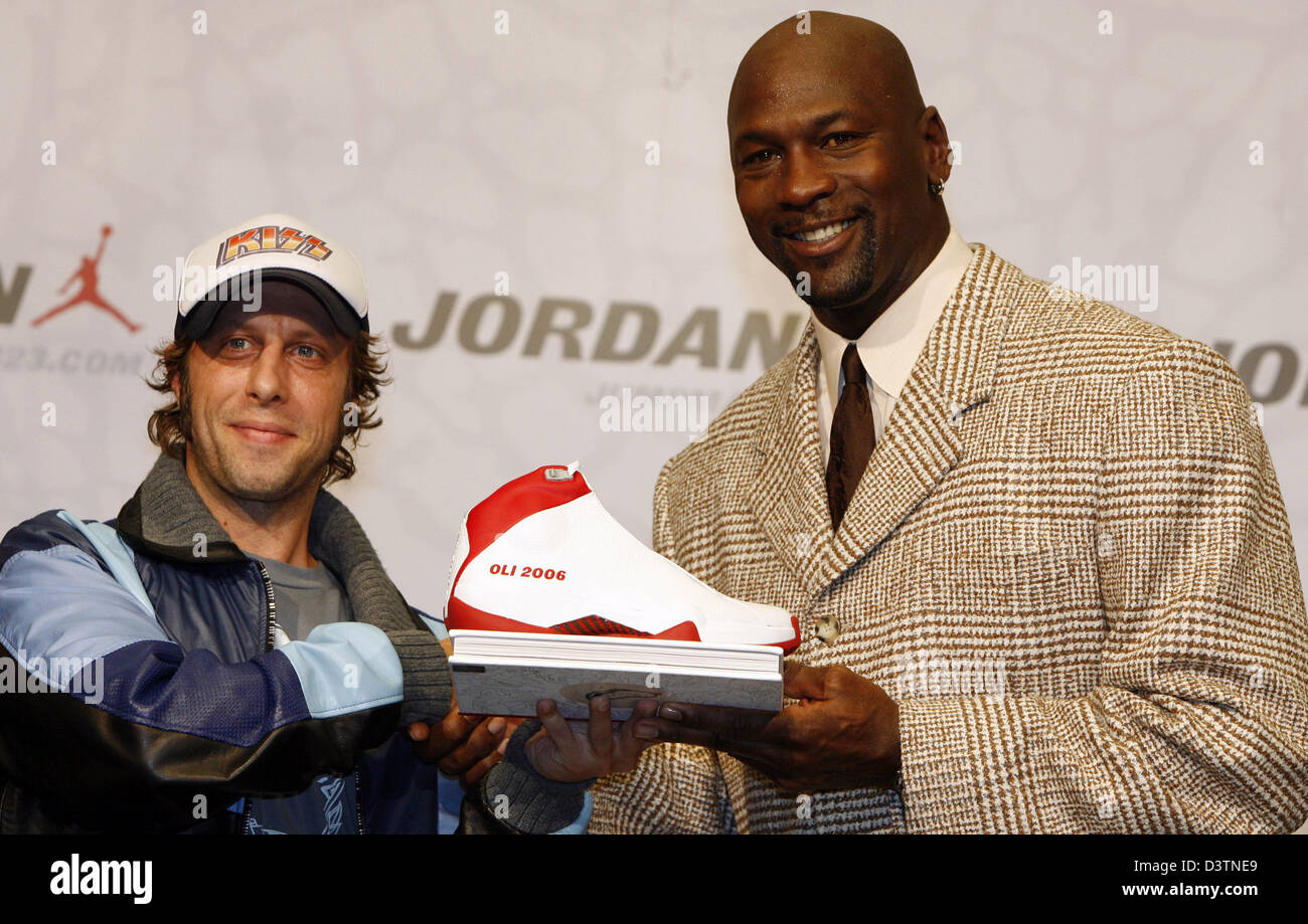 Former basketball superstar Michael Jordan hands a basketball shoe to German actor Oliver Korittke during a press conference in Berlin, Germany, Saturday, 21 October 2006. The designated best basketball player of all times promotes his sports label 'Jordan' in Europe. Photo: Miguel Villagran Stock Photo