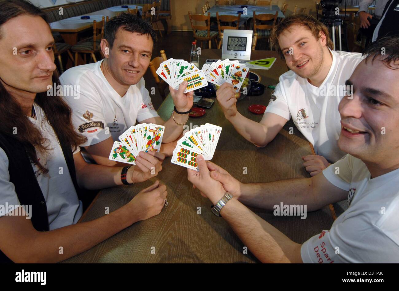 Bernhard Rasch (L-R), Disic Zeljko, Marco Schnelldorfer and Ingo Goetz play the 'Schafkopf' (lit.: 'sheep's head') card game in Aholming, Bavaria, Tuesday, 24 October 2006. With 80 hours of 'Schafkopf' they want to break the world record in non-stop card playing. Photo: Armin Weigel Stock Photo