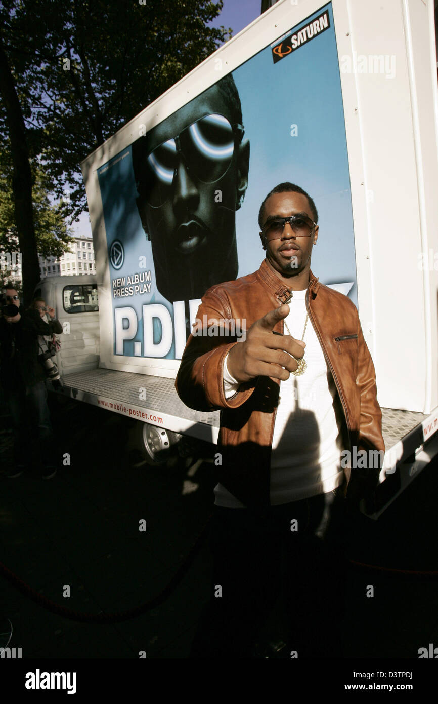 Musician P.Diddy poses in front of a giant poster advertising his