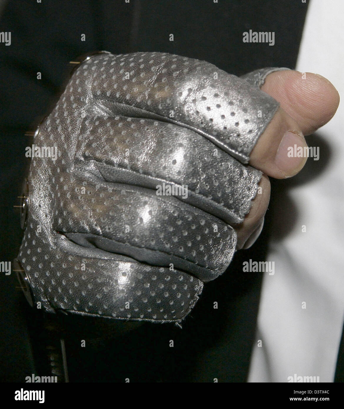 The silver gloves of German fashion designer Karl Lagerfeld open his  photography exhibition 'Open Man Show' in Berlin, Germany, Friday, 24  November 2006. Visitors can eye the photos of Brad Koenig until