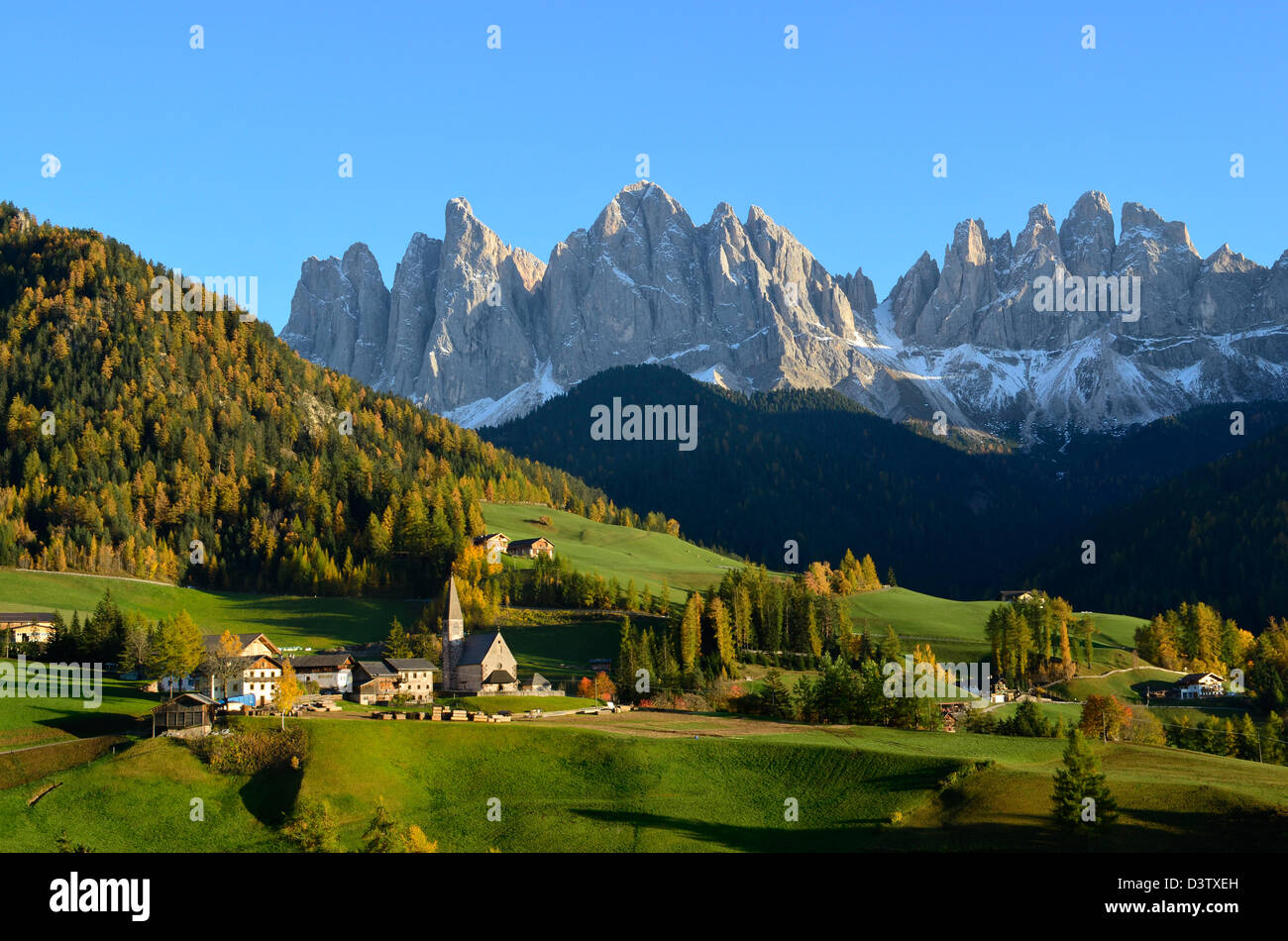 St. Magdalena or Santa Maddalena with its characteristic church in front of the Geisler or Odle Dolomites mountain peaks. Stock Photo