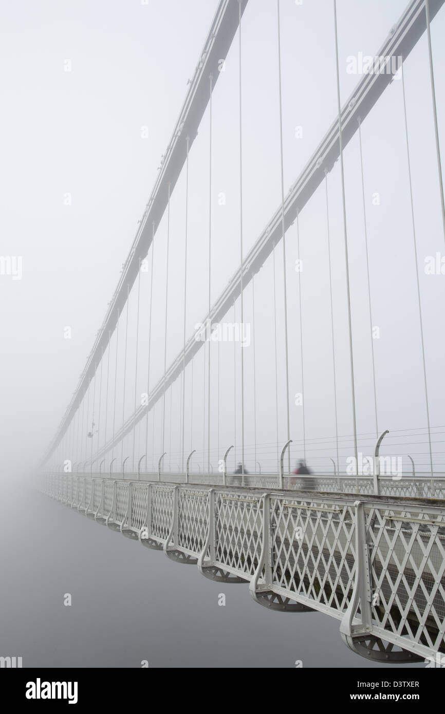 Cycling into the void - Clifton Suspension bridge in the early morning mist Stock Photo