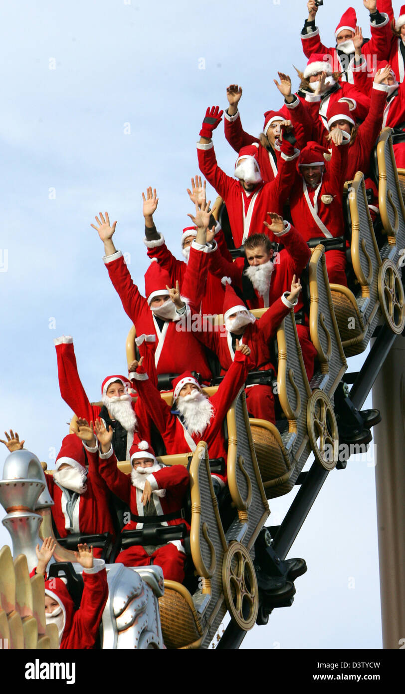 Visitors dressed as Santa Claus ride the rollercoaster at the