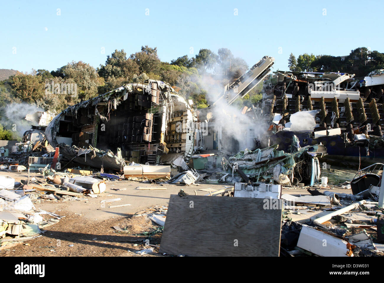 The picture shows a filmset with a wreck of a crashed airplane on the