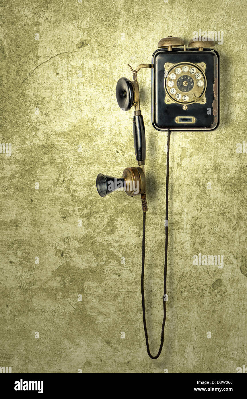 Vintage telephone hanging on the wall hires stock photography and