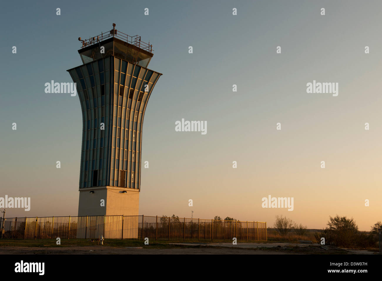 Airport control tower at dawn in an abandoned field Stock Photo