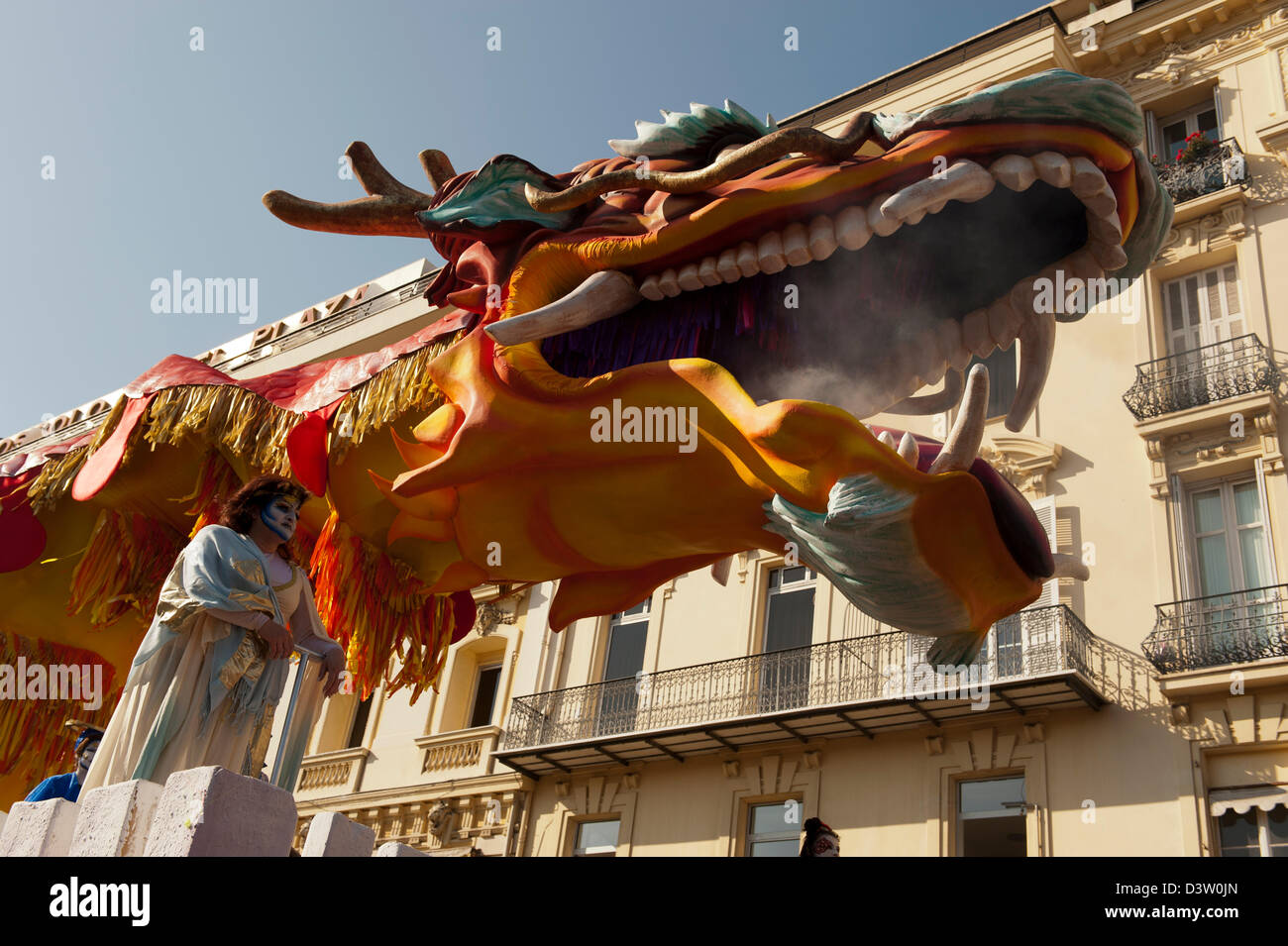 Large dragon float parades down the streets of Nice during Carnival festivities Stock Photo