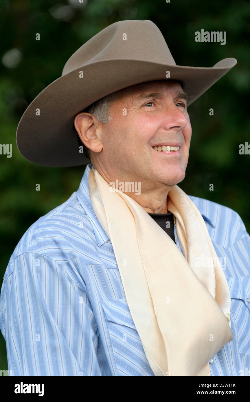 Cowboy head shot with hat and silk kerchief around neck, mature adult and handsome older man. Stock Photo