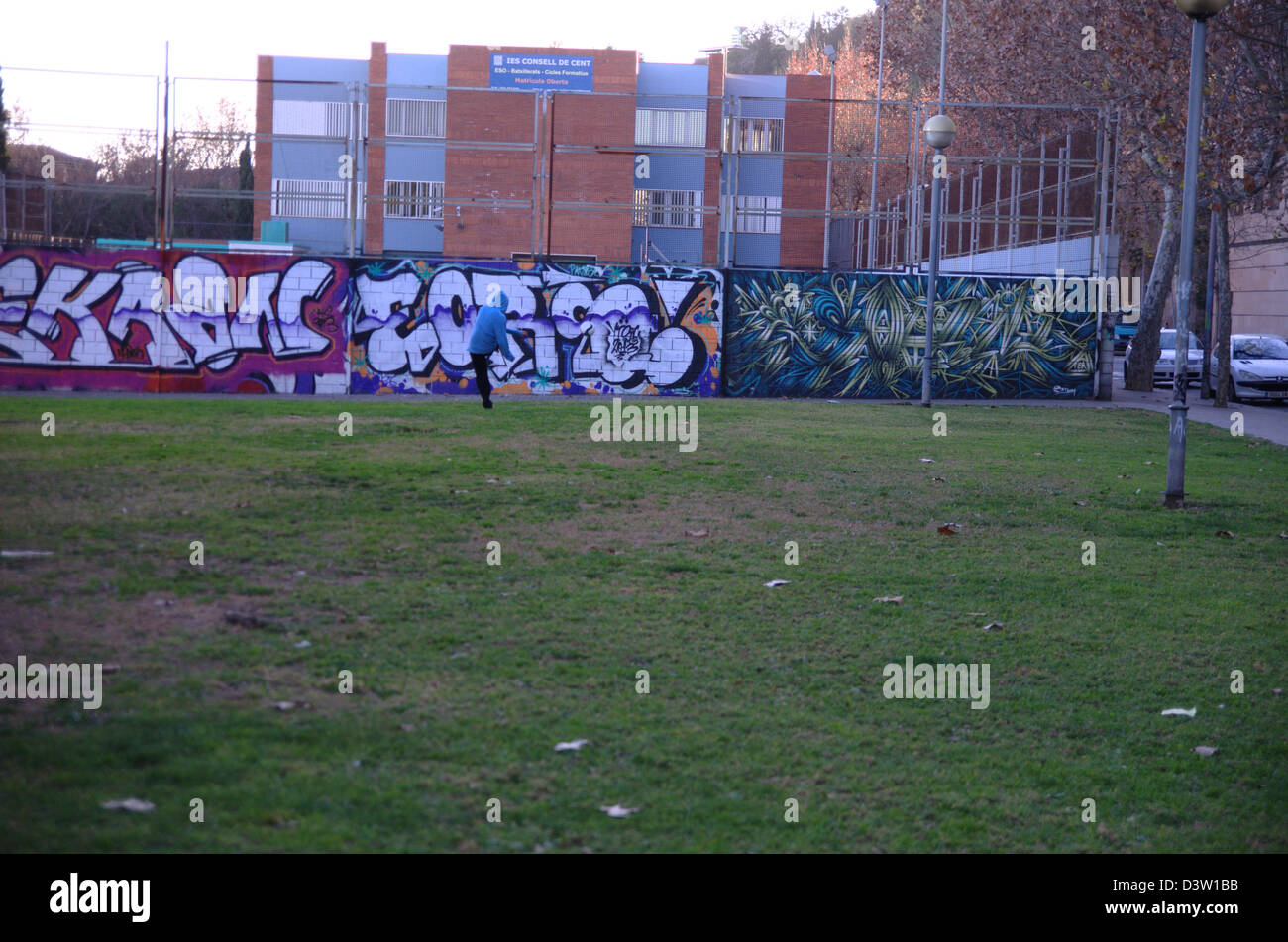 Graffiti in Paral·lel Avenue in Barcelona. Boy playing soccer in suburbian surroundings Stock Photo