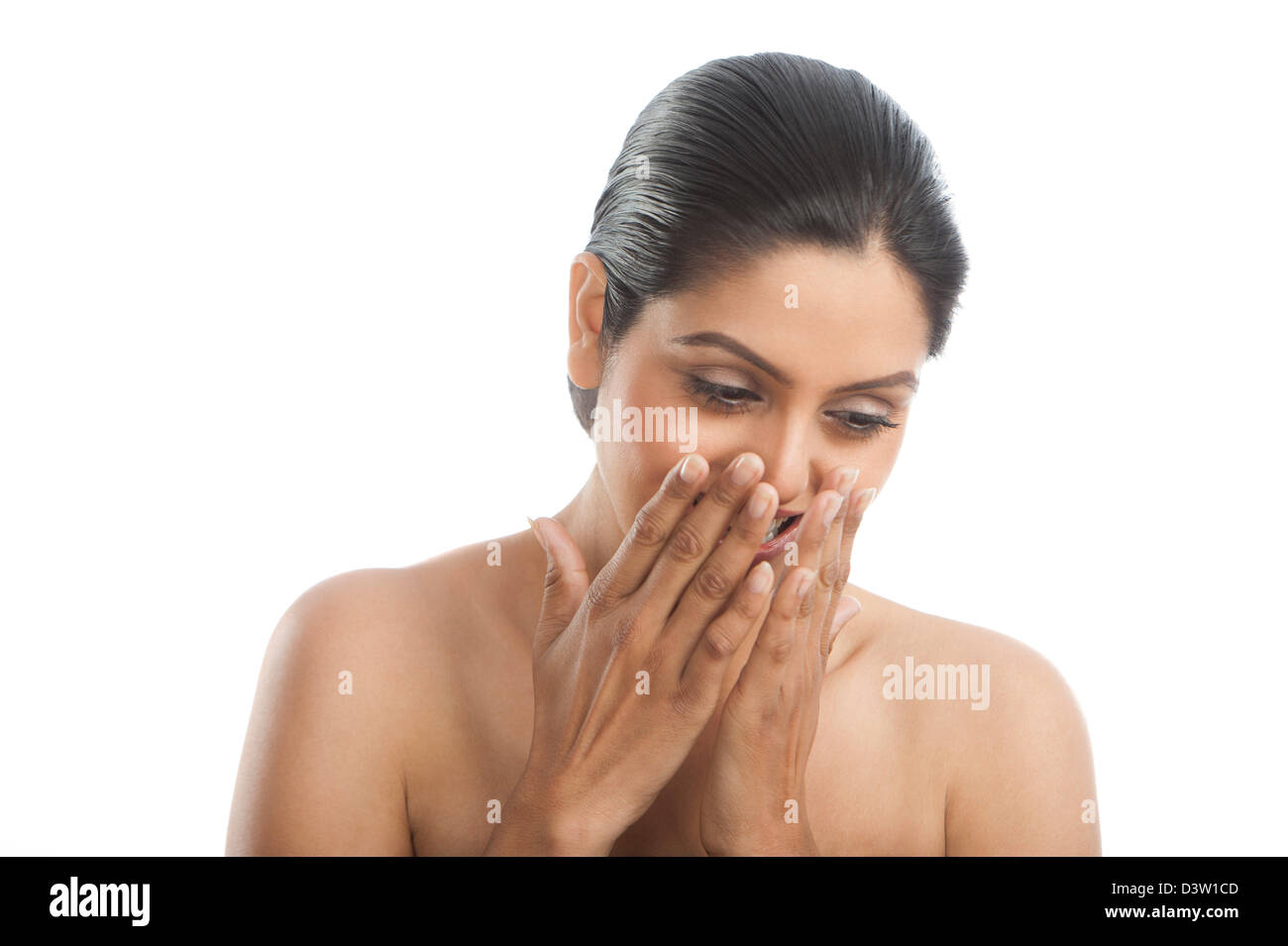 Woman covering her mouth with her hands and smiling Stock Photo - Alamy