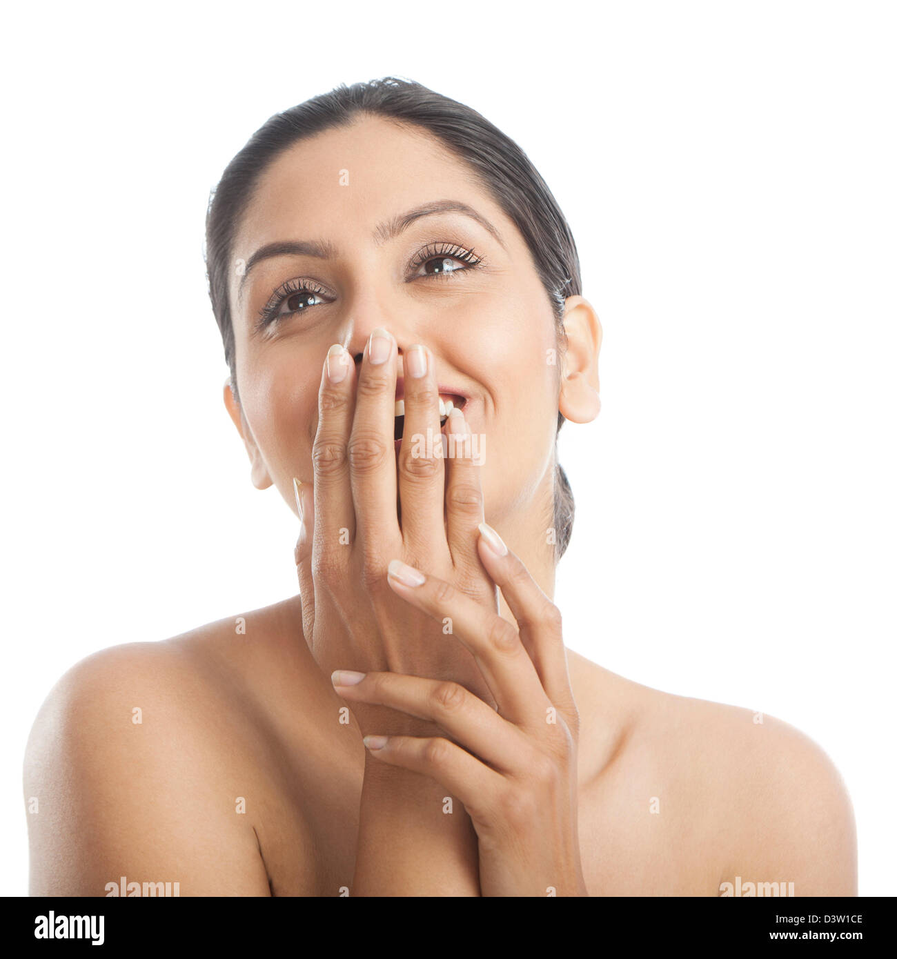 Woman covering her mouth with her hands and smiling Stock Photo - Alamy