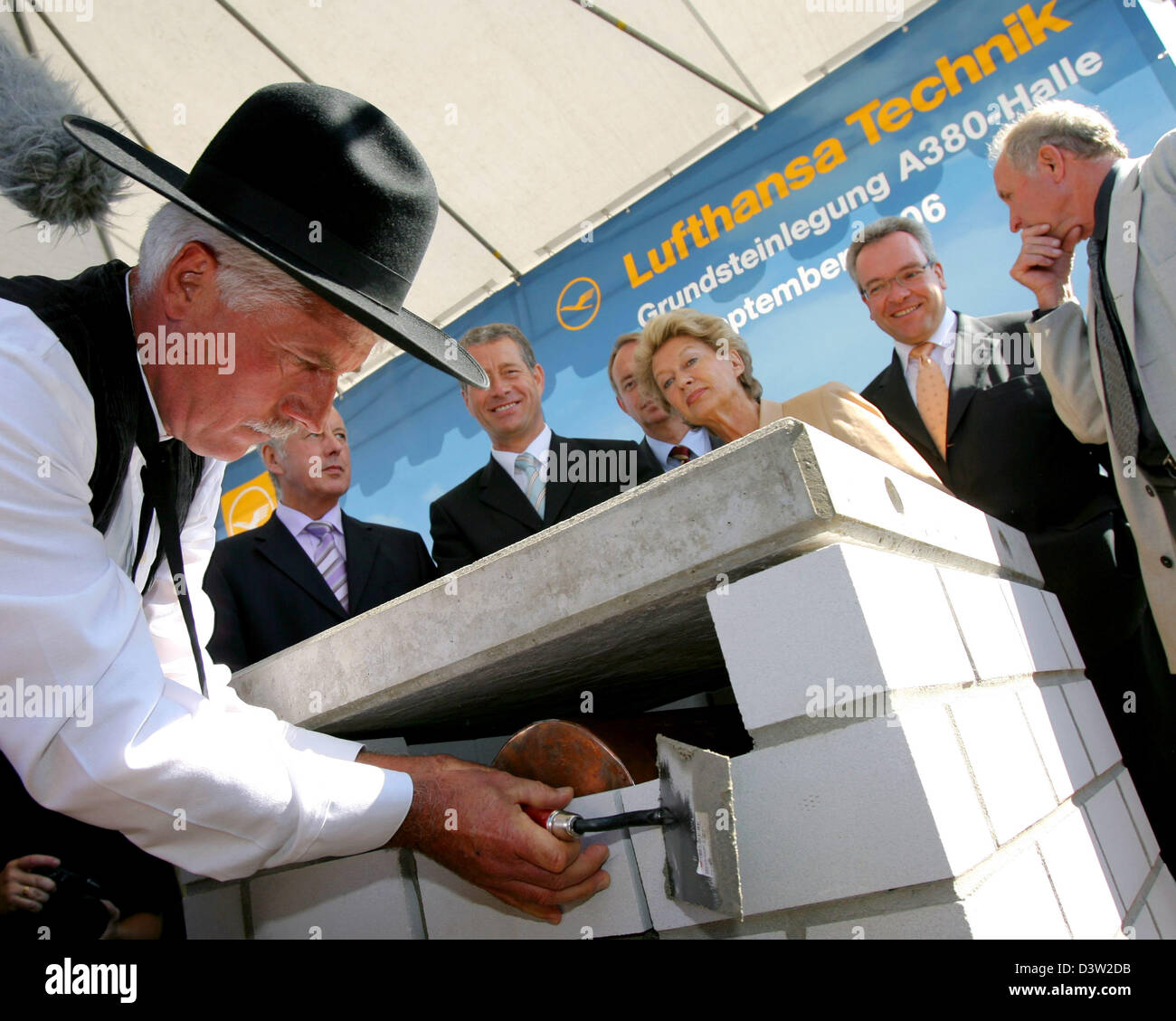 Foreman Wolfgang Breitenbach (L) lays the forner stone in the presence of (L-R) Fraport board member Manfred Schoelch, Hessian Minister of Economy Alois Rhiel, CEO of Lufthansa Technik August Wilhelm Henningsen, Lord Mayor of Frankfurt Petra Roth, Lufthansa board member Stefan Lauer and architect Volkwin Marg for the new Lufthansa maintenance hall at the Rhein Main International ai Stock Photo