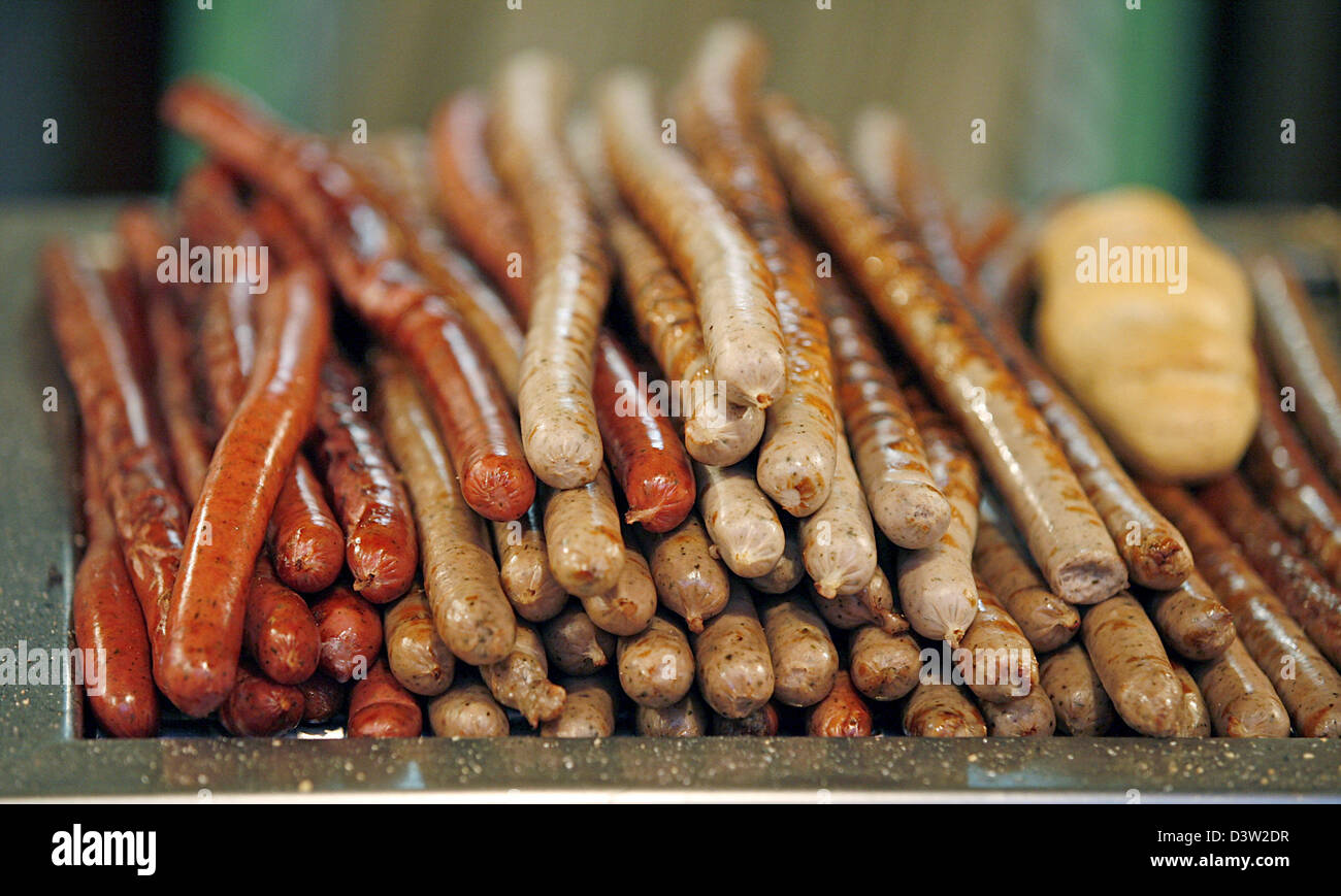 Two kinds of fried sausages are ready for sale at a snack stand on the