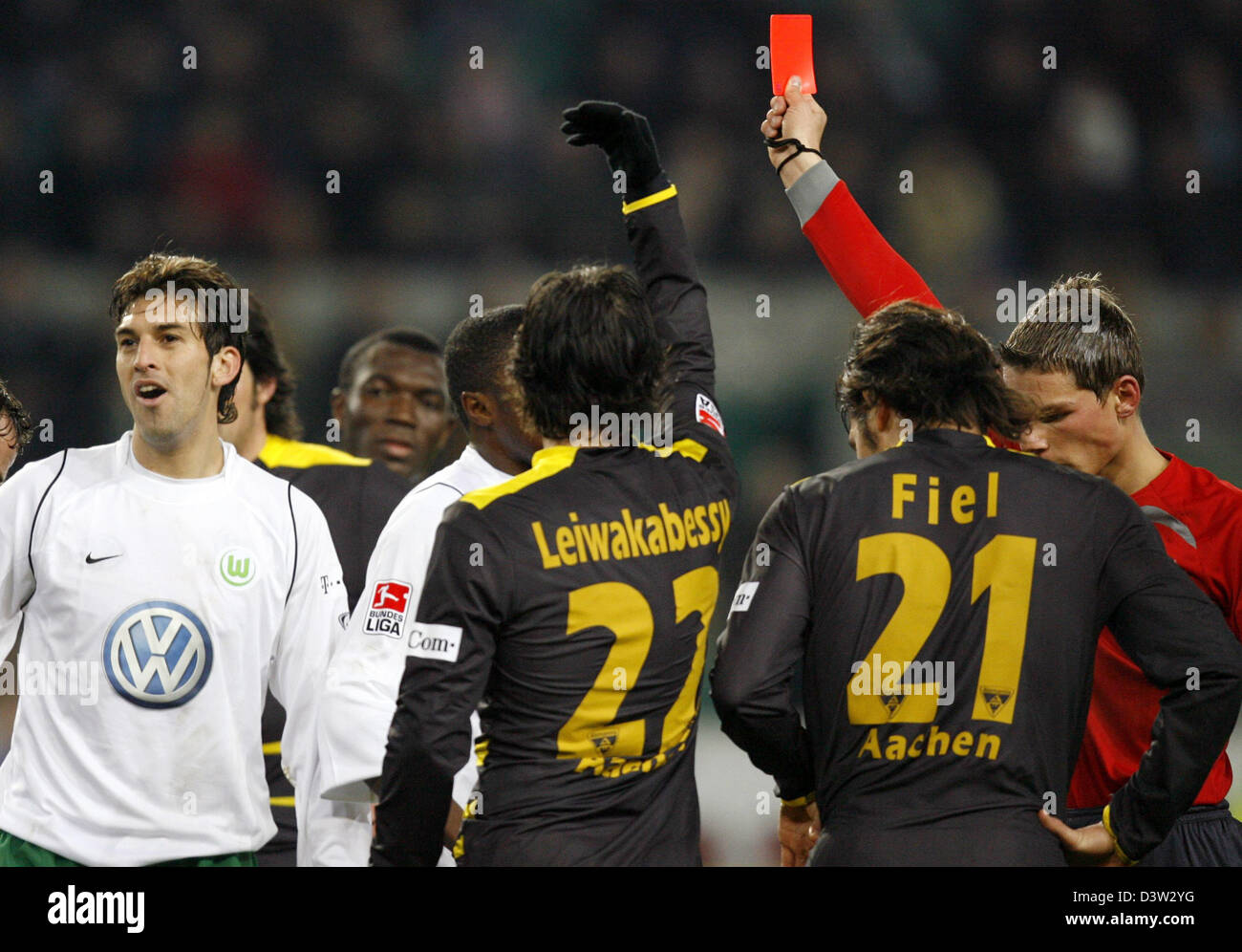 Referee Michael Kempter (R) sends off Wolfsburg's Facundo Quiroga (C ...
