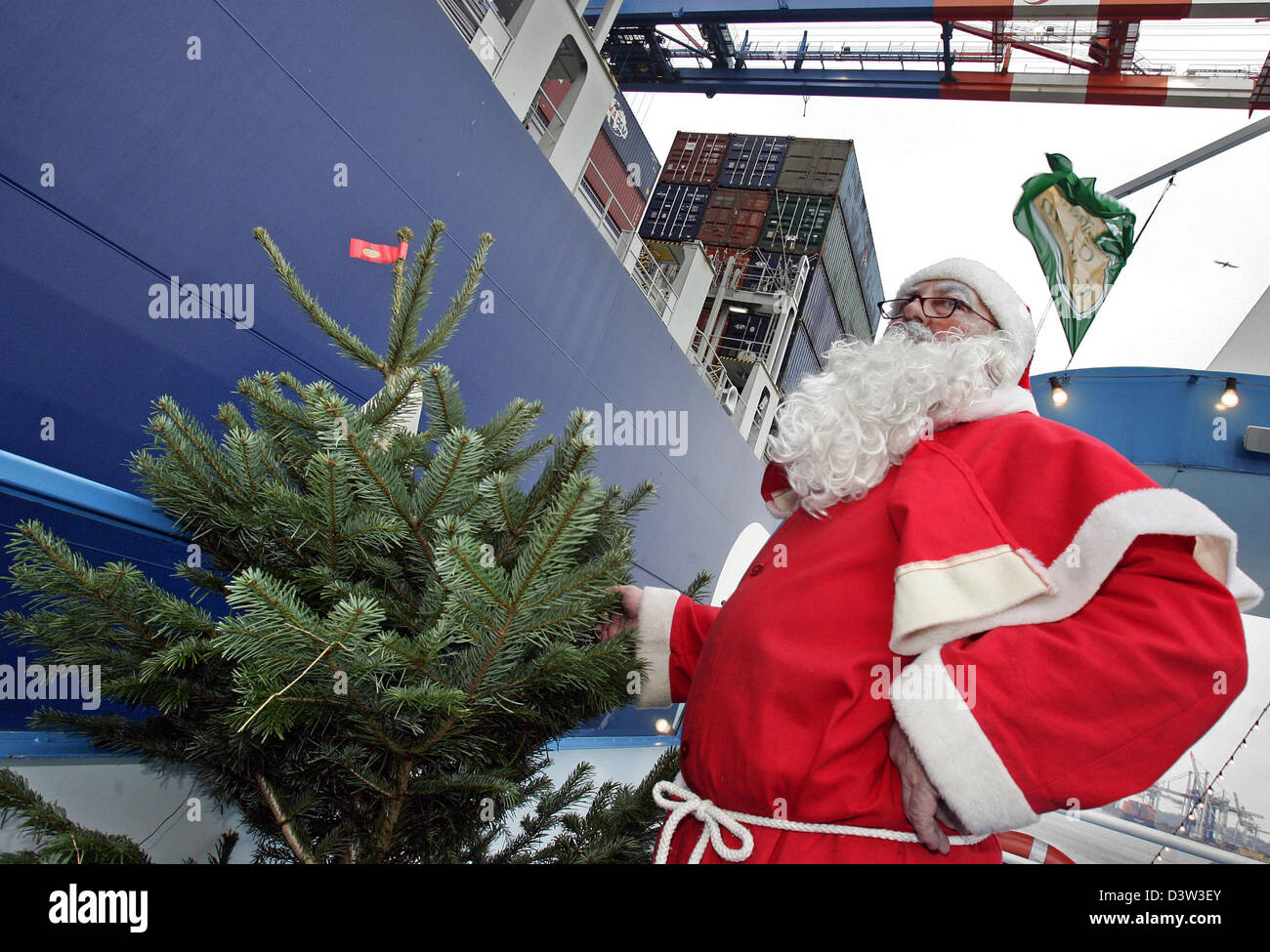 A Santa Claus delivers a christmas tree to a container ship in the Shipping By Christmas