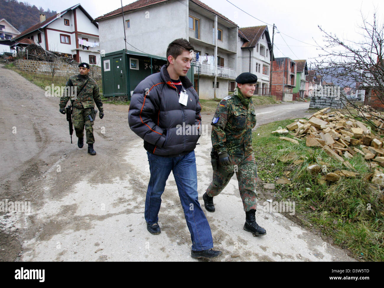 German Bundeswehr soldiers patrol with an interpreter the village ...