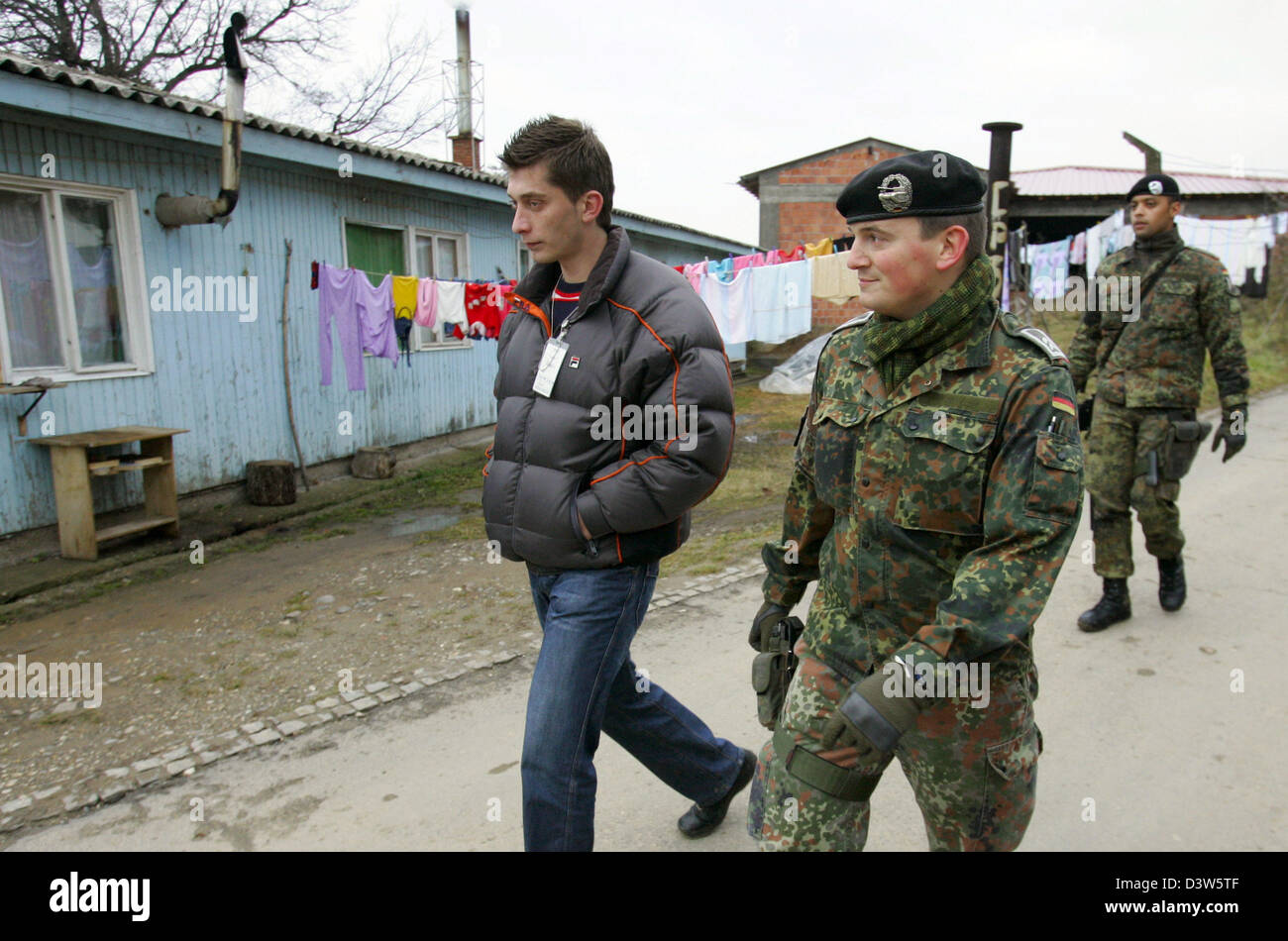 German Bundeswehr soldiers patrol with an interpreter the village ...
