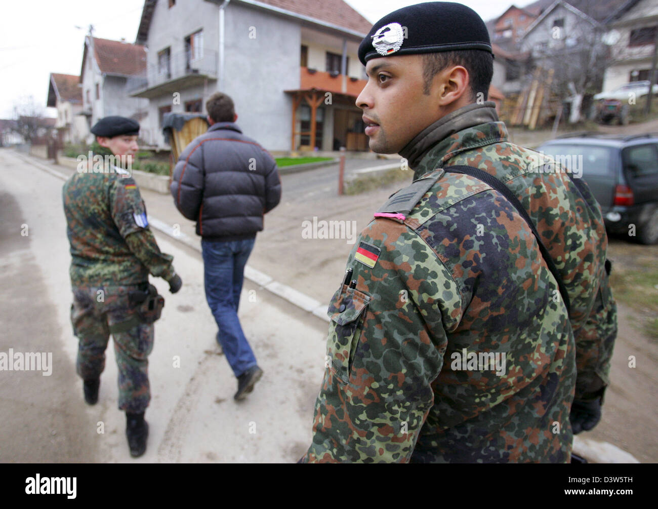 German Bundeswehr soldiers patrol with an interpreter the village ...