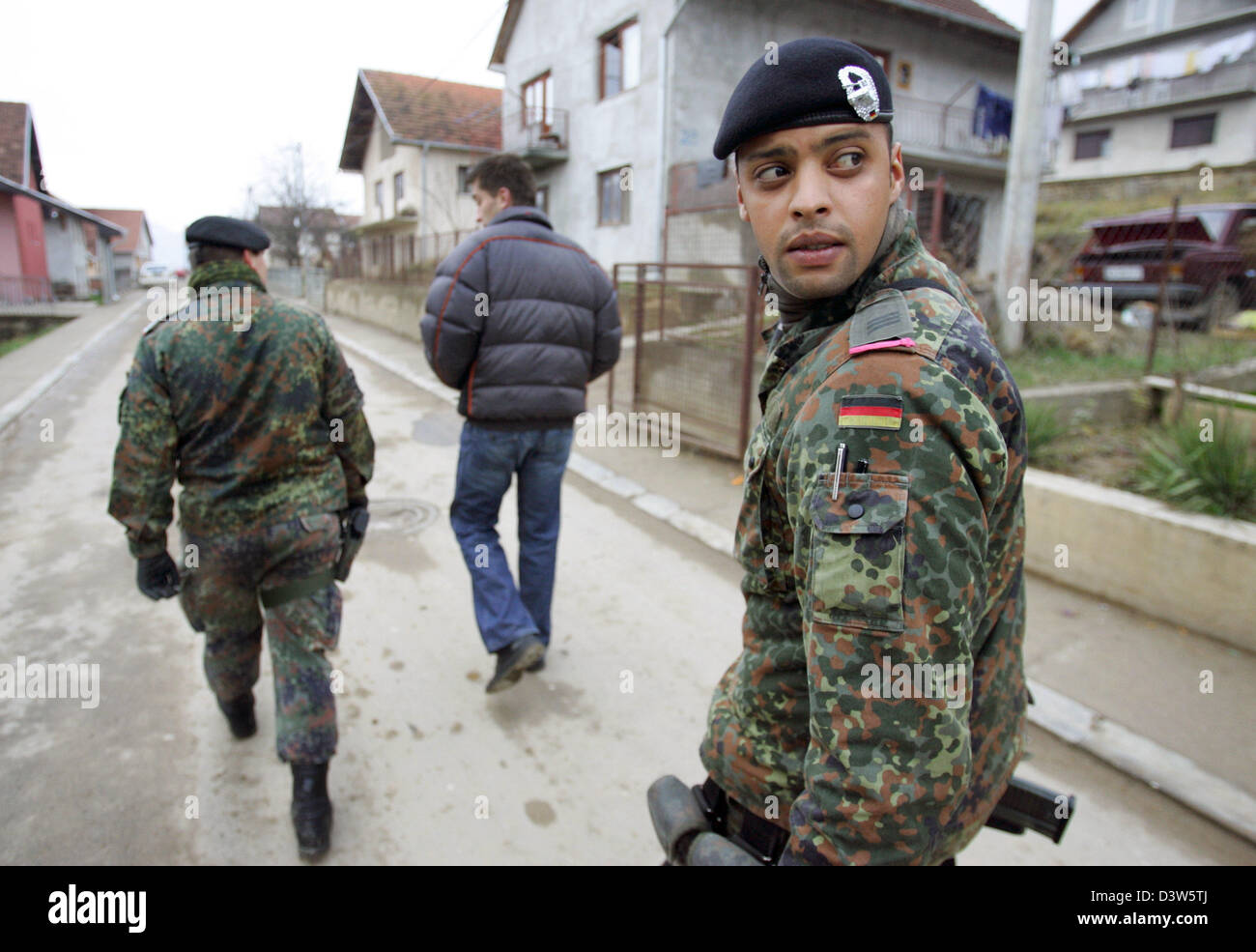 German Bundeswehr soldiers patrol with an interpreter the village ...