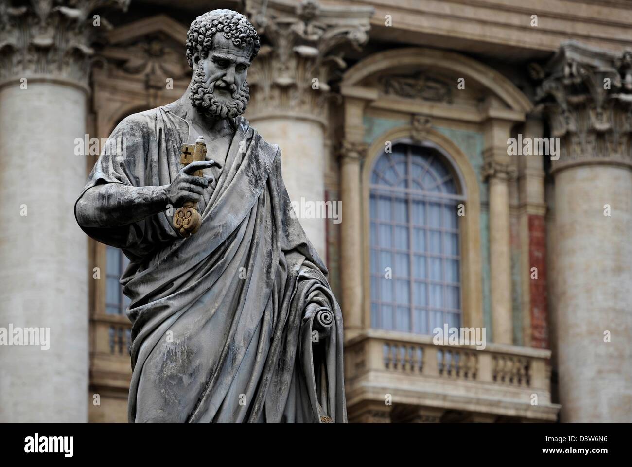 Statue of Saint Peter stands under gray sky on St. Peters Square in Vatikan, 22 February 2013