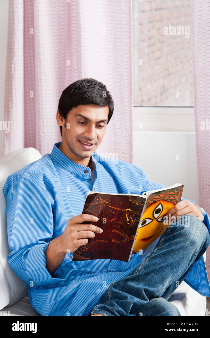 Bengali man reading a magazine Stock Photo - Alamy