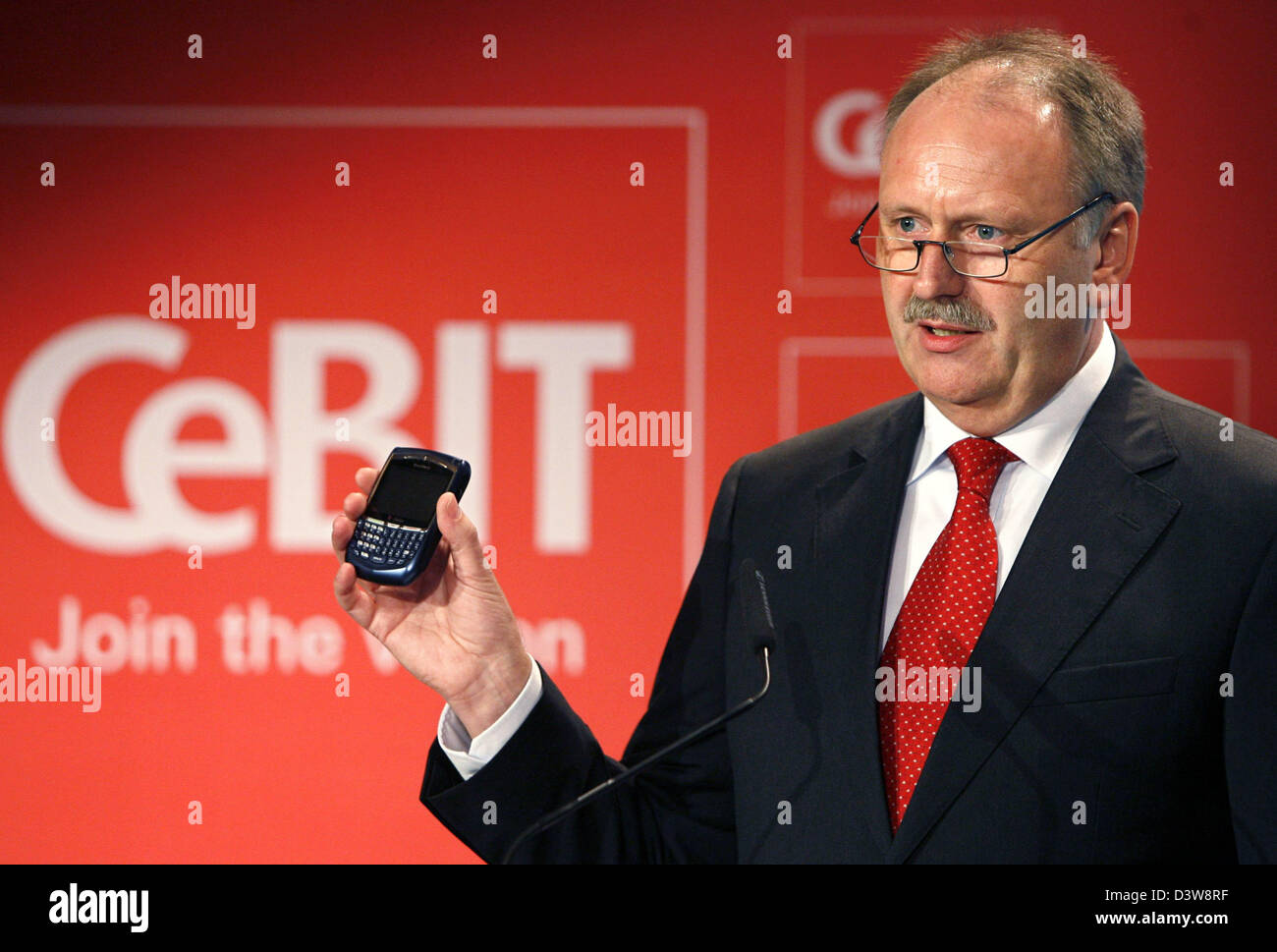 Ernst Raue, the CeBIT-director and member of the board of the 'Deutsche Messe AG Hanover', gestures at press conference in front of the CeBIT logo in Hanover, Germany, Tuesday, 23 January 2007. The computer trade fair CeBIT (15th to 21st March 2007) will record a major decrease in exhibition space due to the cancellations of big companies such as Nokia and Motorola. The trade fair' Stock Photo
