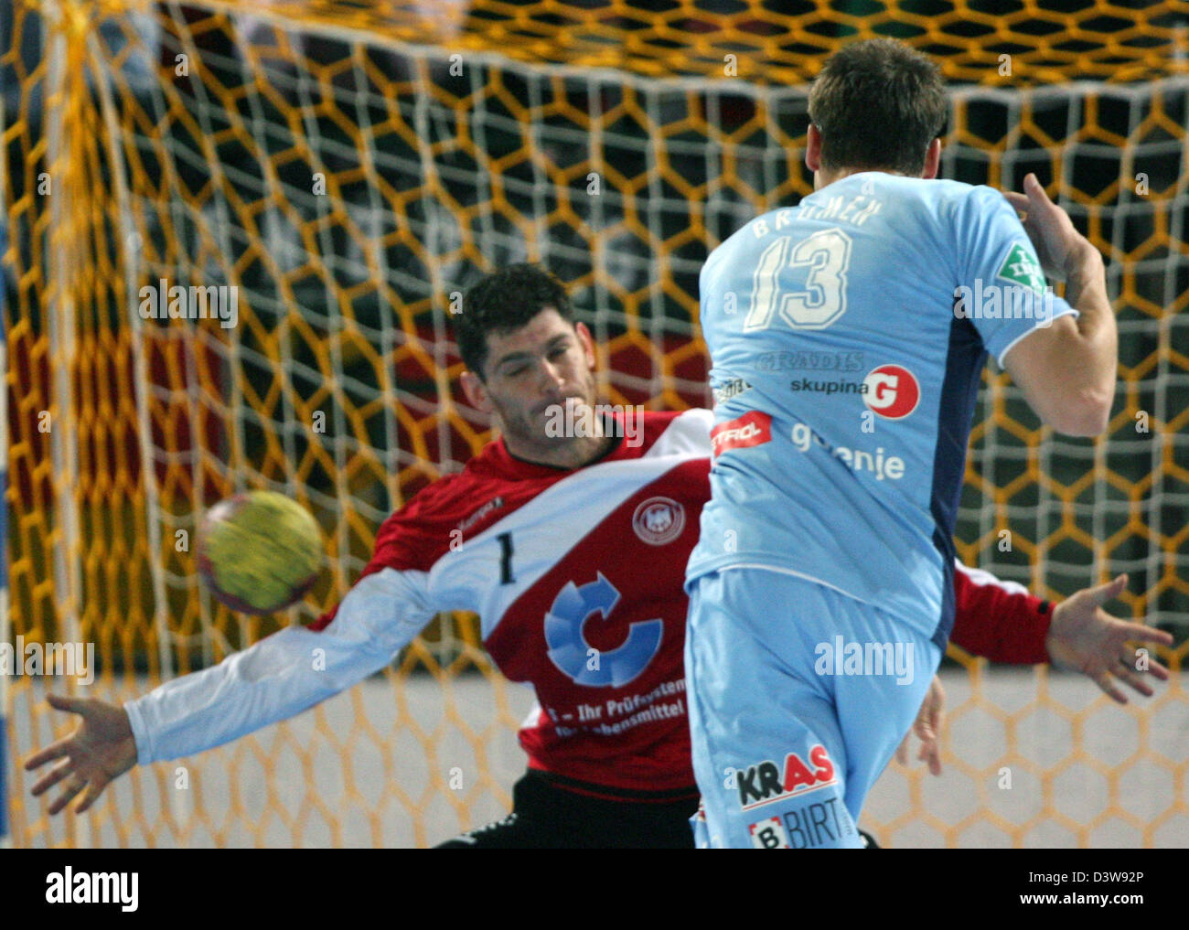 German international goalie Henning Fritz (L) saves a throw by Slovene